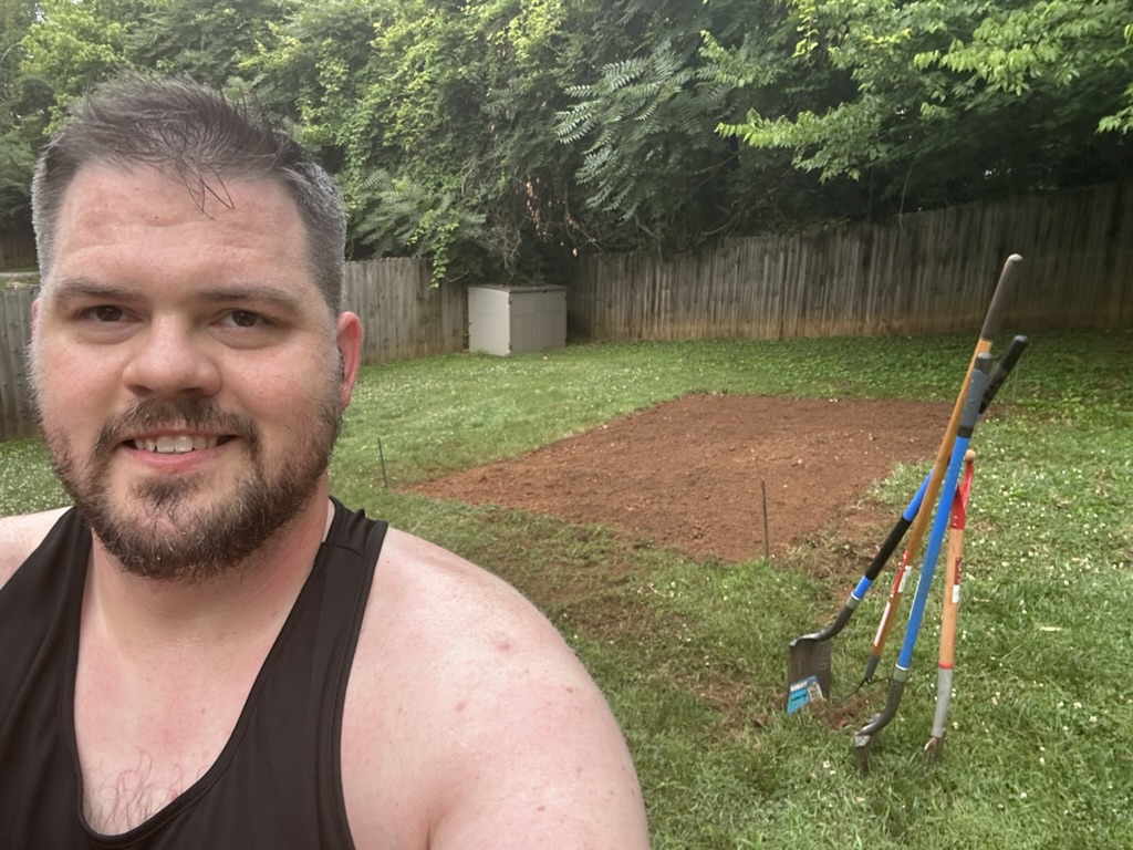 Nathan beside the cleared plot, June 25
